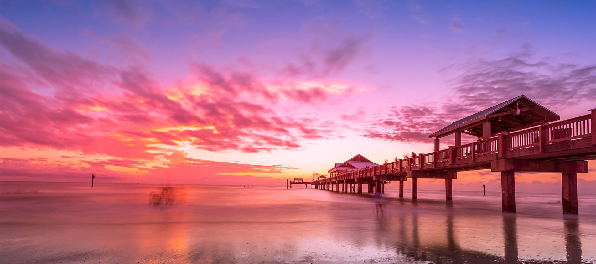 Pier 60 and the white-sand shoreline of Clearwater Beach, Florida at sunset